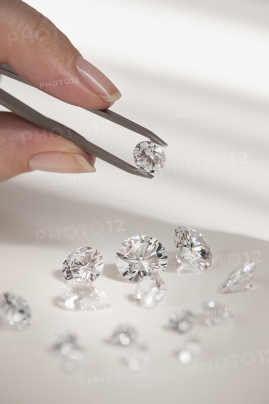 Studio shot of woman holding diamonds.