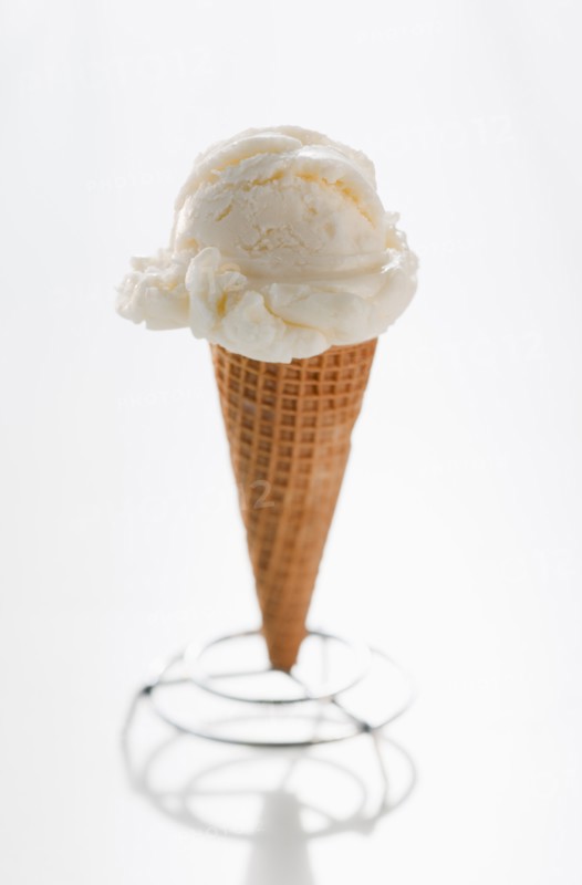 Close up of vanilla ice cream cone.