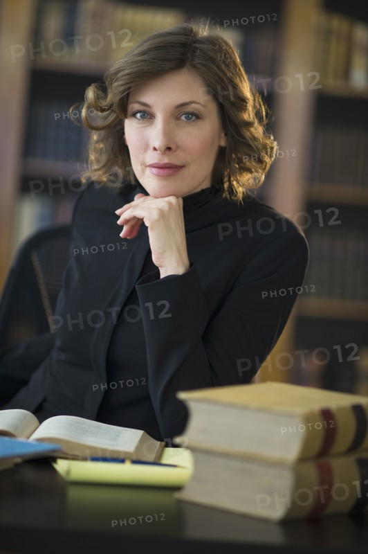 Portrait of woman studying in library.