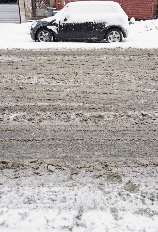 USA, New York State, Brooklyn, Williamsburg, tire tracks on snow covered street. Photo: Jamie Grill Photography