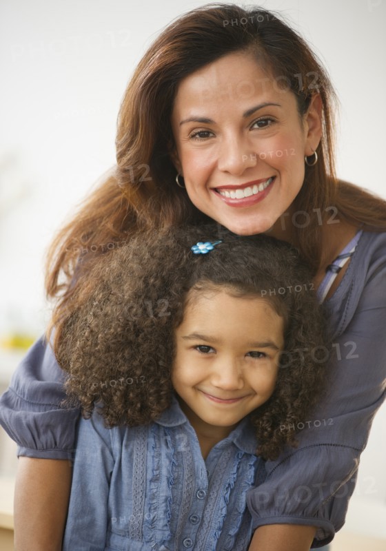 Portrait of smiling mother and daughter (6-7).