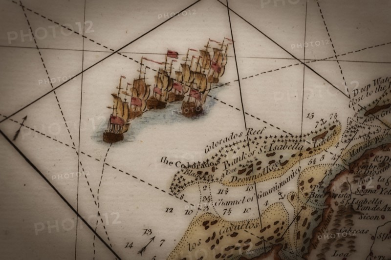 Close up of antique map of coastline of England with tall ships.
