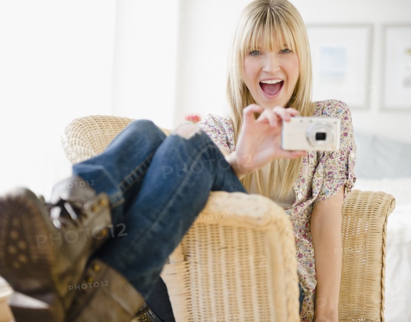 Young woman taking picture. Photo: Jamie Grill Photography