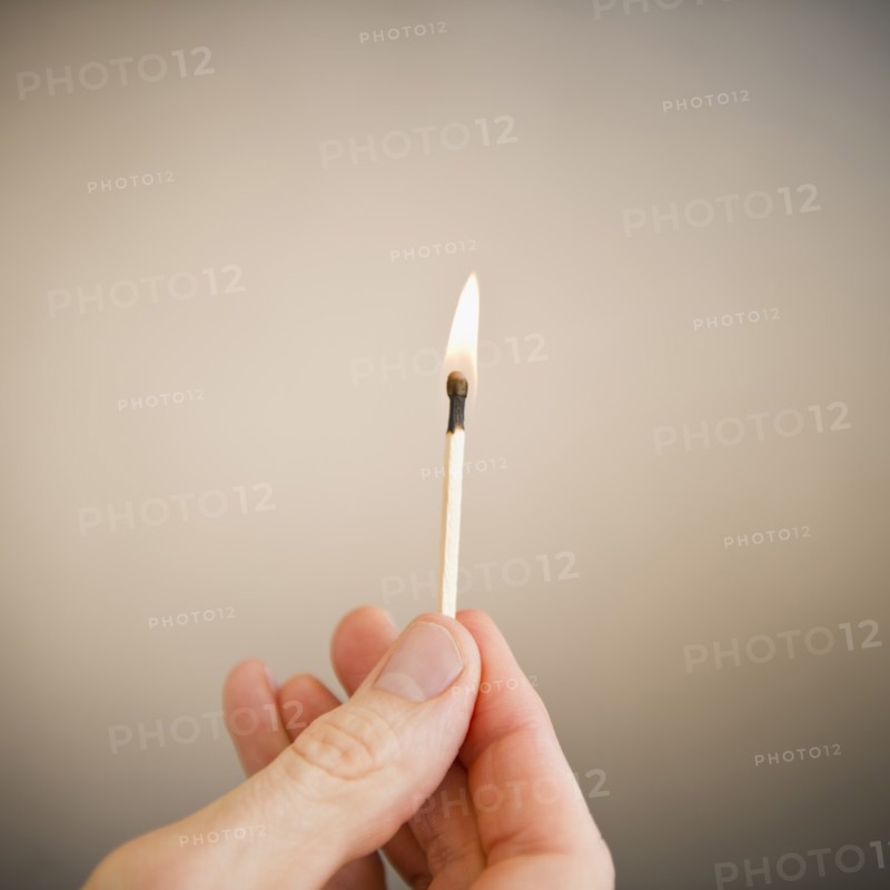 Hand holding match. Photo: Jamie Grill Photography