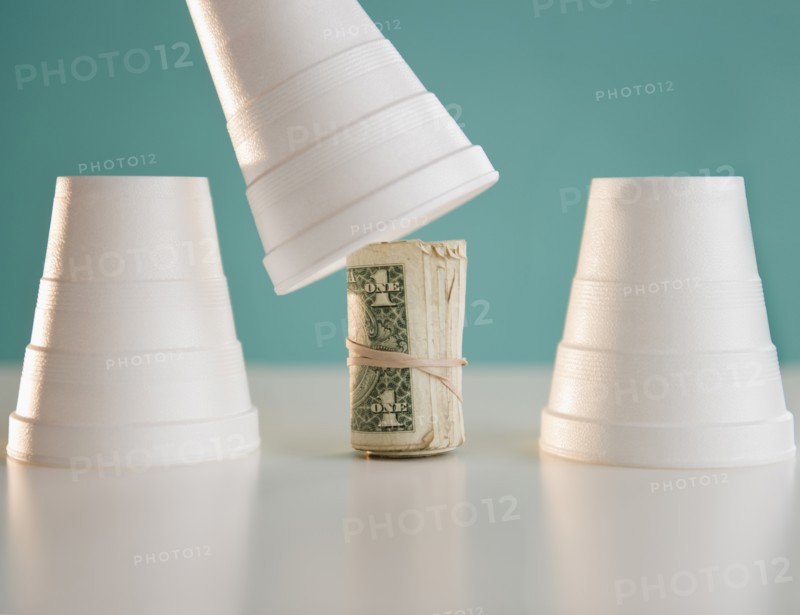 Studio shot of money under cup. Photo: Jamie Grill Photography