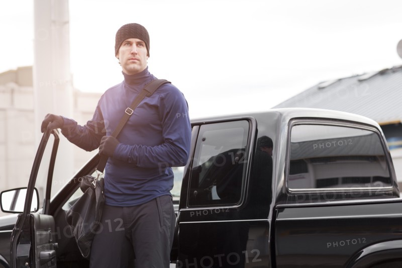 USA, Washington, Seattle, man in workout wear getting out of truck. Photo : Take A Pix Media