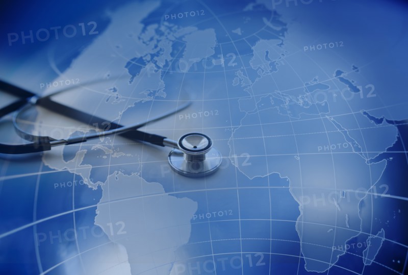 Close up of stethoscope with world map in background.