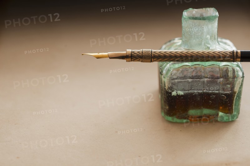 Close up of antique ink well and pen.