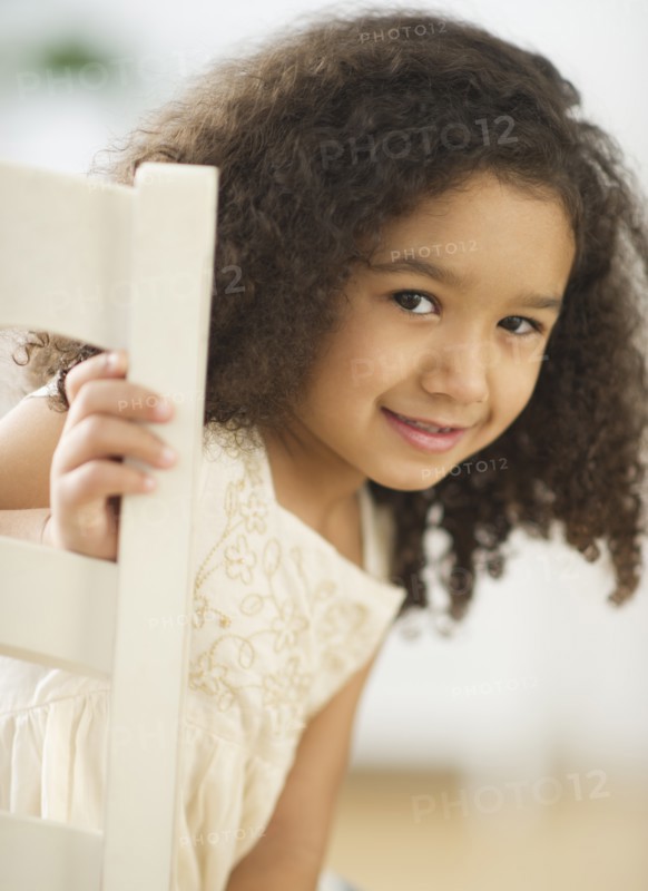 Portrait of smiling girl (6-7) with afro.