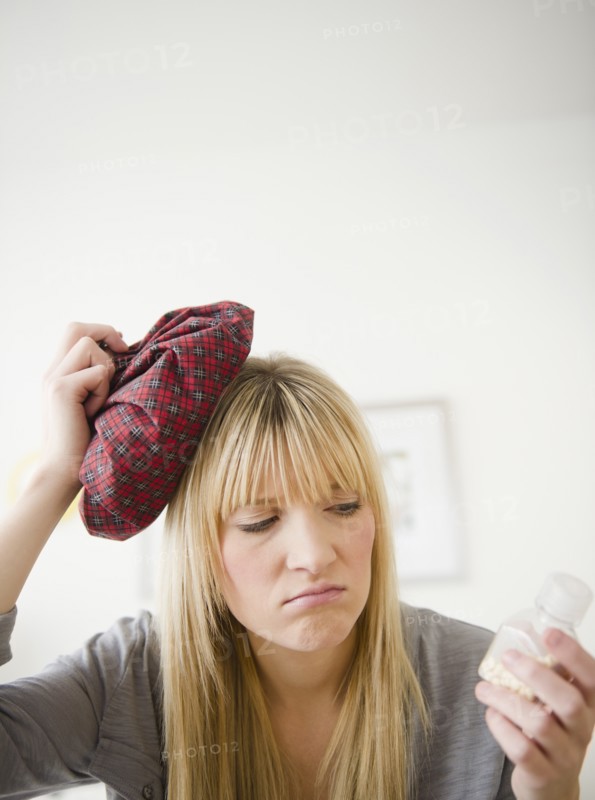 Young woman having headache. Photo: Jamie Grill Photography