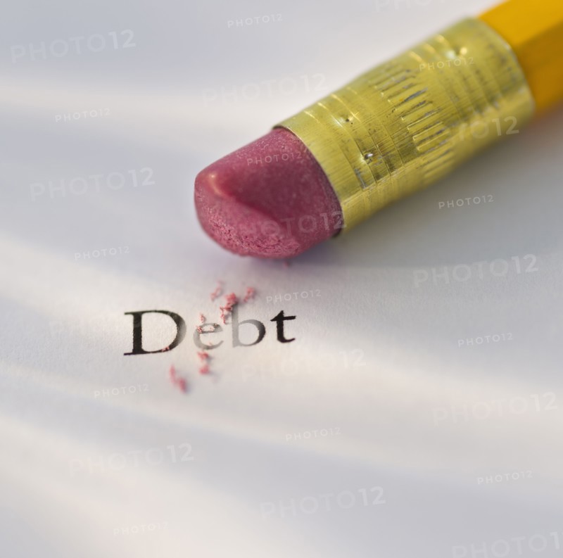 Studio shot of pencil erasing the word debt from piece of paper. Photo: Daniel Grill