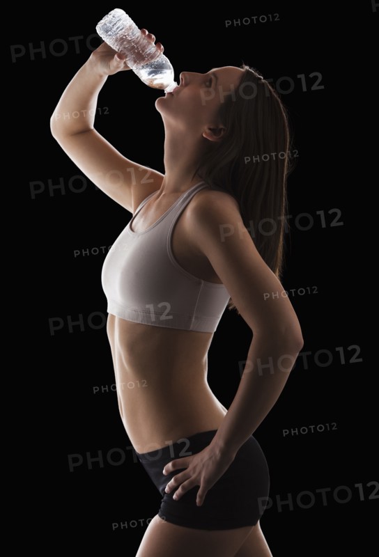 Young woman drinking water from bottle. Photo: Mike Kemp
