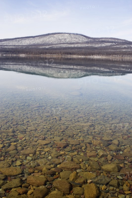 USA, Colorado, Hills reflected in lake. Photo : Noah Clayton