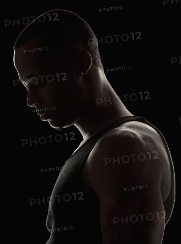 Studio shot of muscular young man wearing tank top. Photo: Mike Kemp