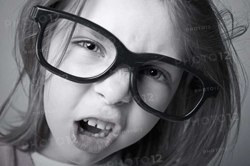 Close-up of girl (6-7) shouting. Photo : Justin Paget