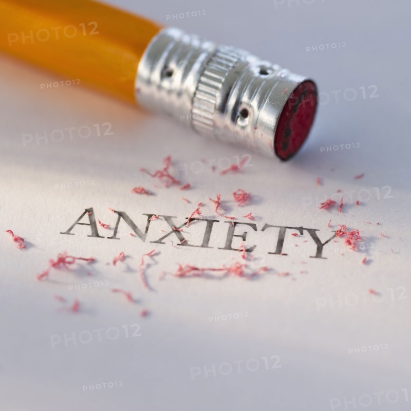 Studio shot of pencil erasing the word anxiety from piece of paper. Photo: Daniel Grill
