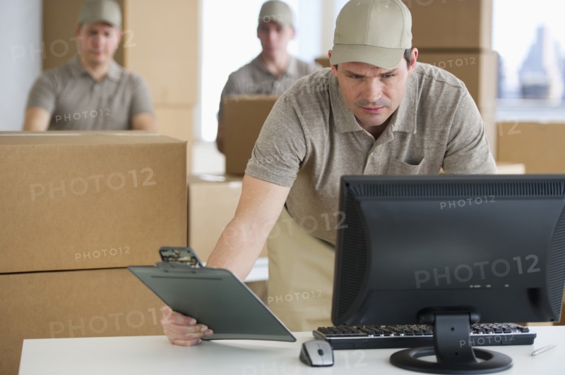 Man checking checklist in warehouse.
