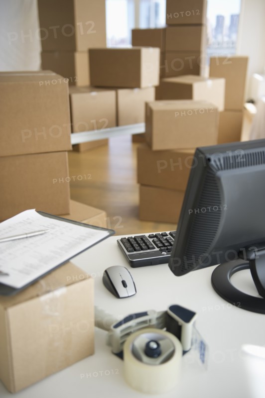 Boxes and computer at delivery warehouse.