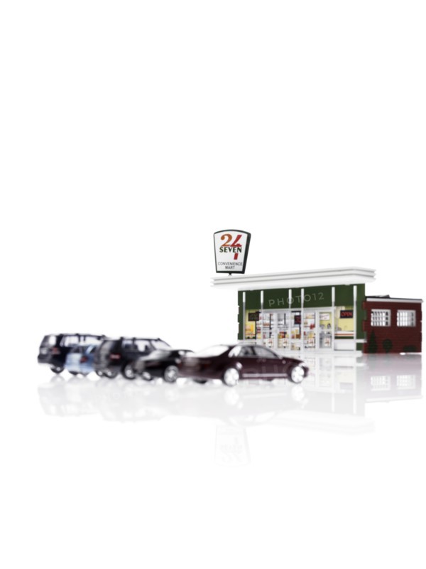 Toy cars in front of toy gas station. Photo : David Arky