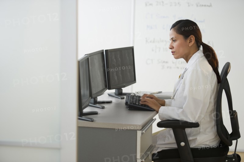 Female doctor making notes.