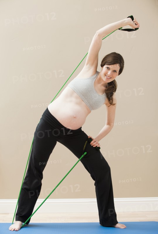 Young woman stretching with skipping-rope. Photo: Mike Kemp
