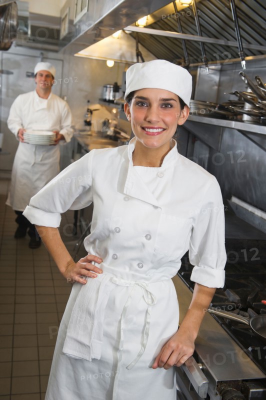 Chef and cook in commercial kitchen.