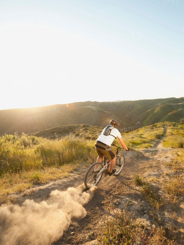 USA, California, Laguna Beach, Man cycling down hill.