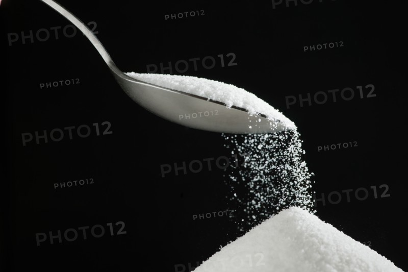 Spoon and heap of sugar.