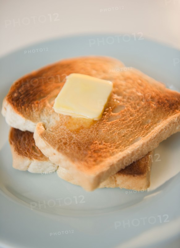 Close up of toasts with butter on plate. Photo : Jamie Grill Photography