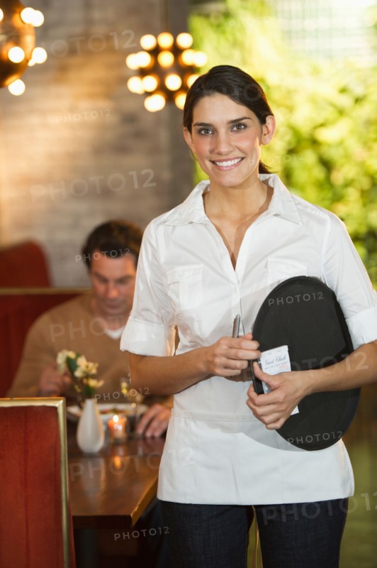 Smiling waitress in restaurant.