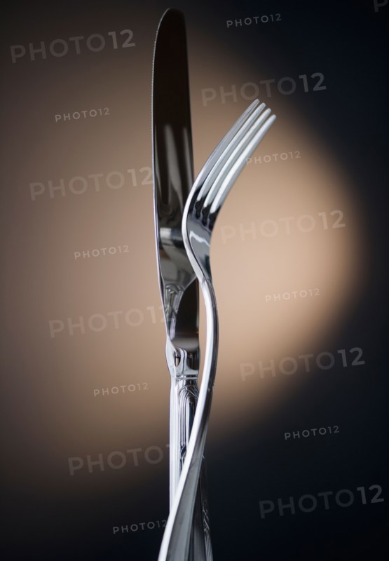 Close up of fork and knife on black background. Photo : Jamie Grill Photography