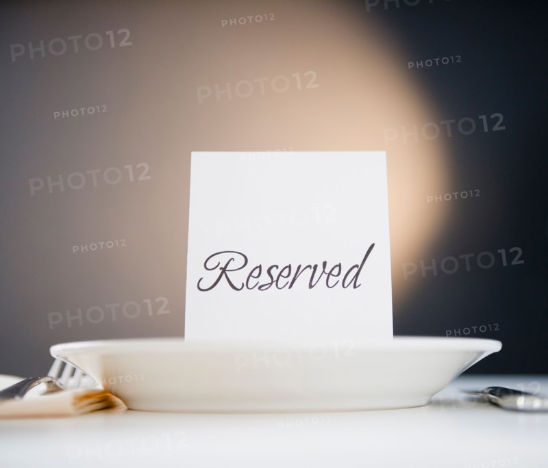 Reserved sign on place setting, studio shot. Photo : Jamie Grill Photography