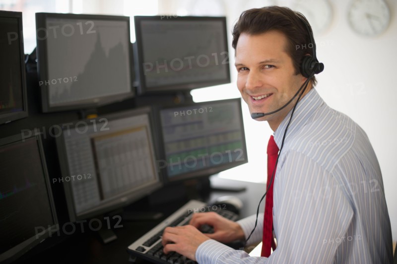Portrait of financial worker analyzing data displayed on computer screen.