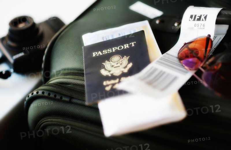 Close up of passport and travel accessories.