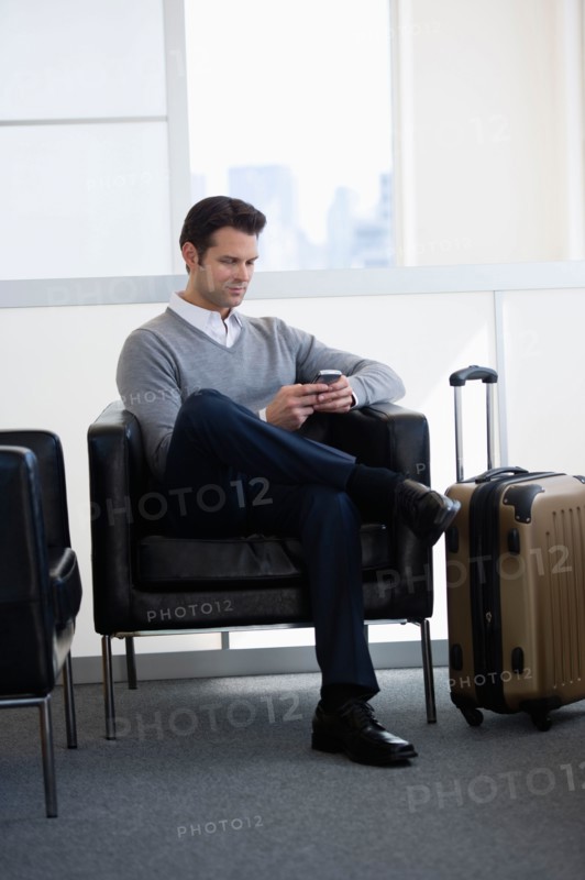 Businessman sitting in airport lounge.