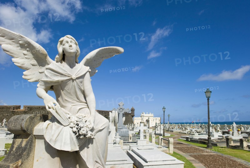 Puerto Rico, Old San Juan, Santa Maria Magdalena Cemetery with El Morro Fortress in background .