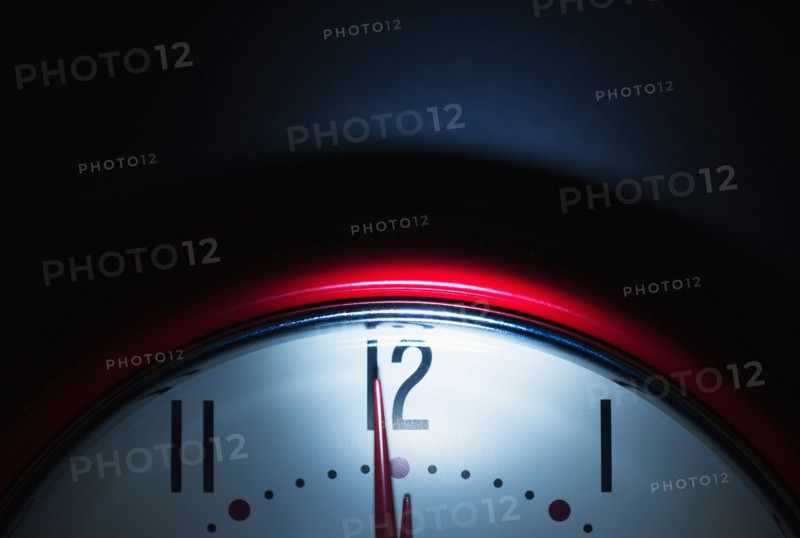 Close up of clock face showing midnight.