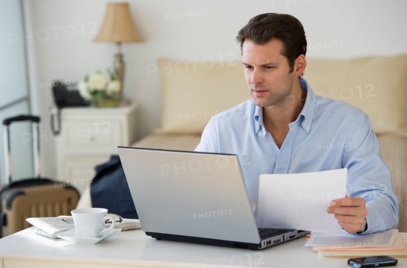 Man using laptop at home office.