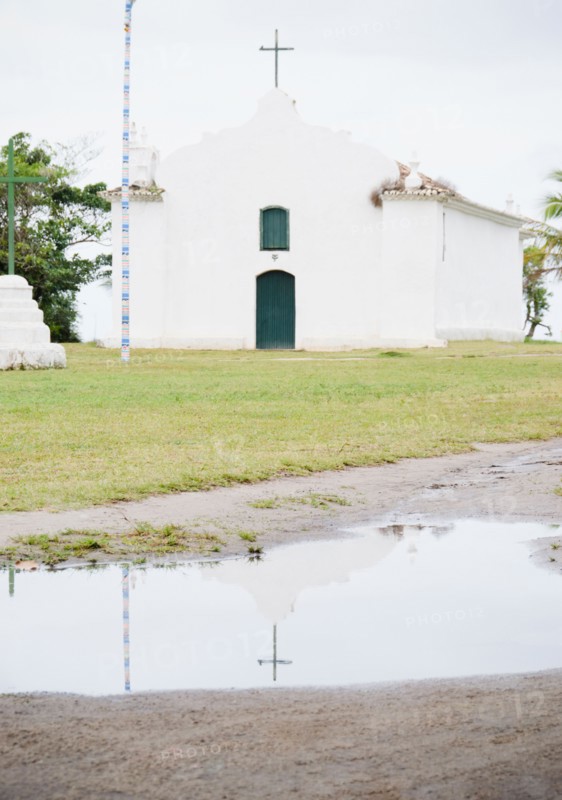 Brazil, Bahia, Trancoso, Church reflecting in puddle. Photo : Jamie Grill Photography