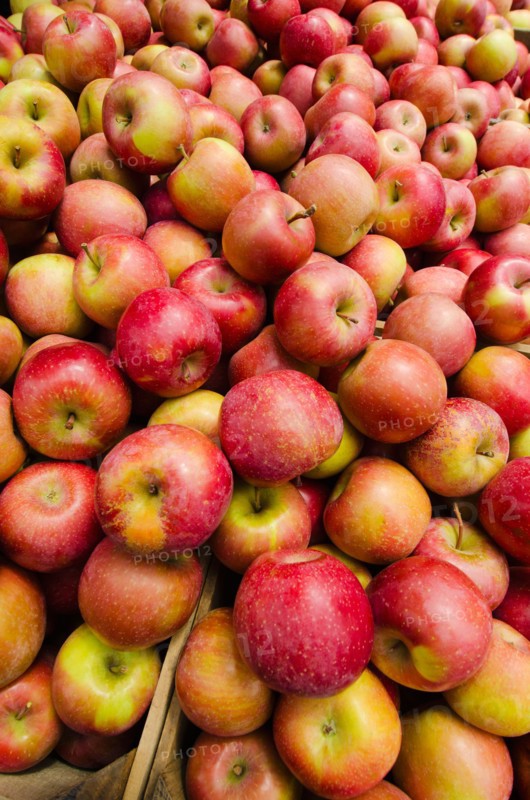 Stack of apples on market stall.
