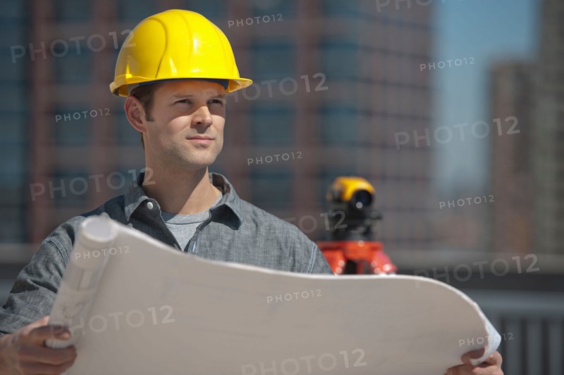 Worker holding blueprint.