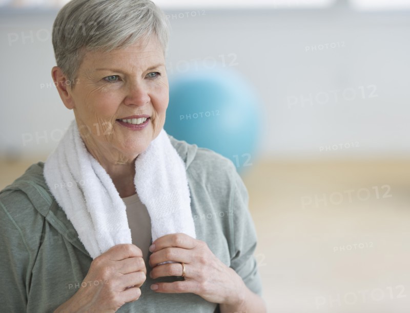 Smiling senior woman in gym.