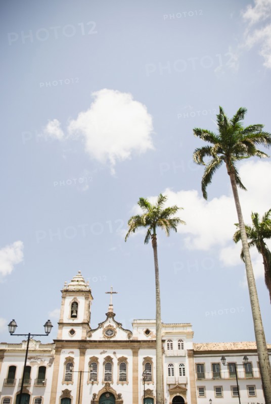 Brazil, Bahia, Salvador De Bahia, Facade of old church with palm trees in front. Photo : Jamie Grill Photography