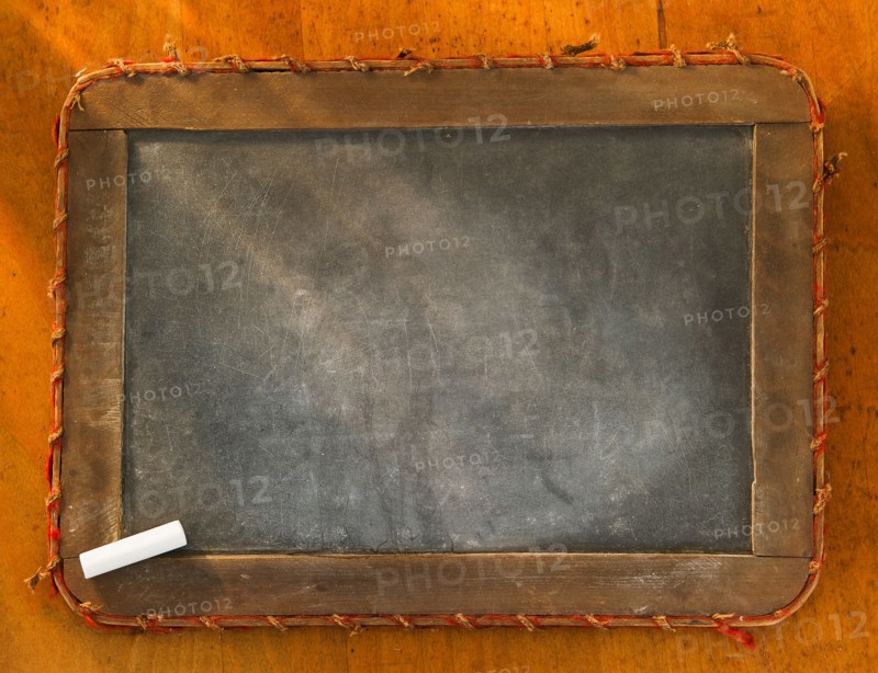 Empty chalkboard with chalk, studio shot. Photo : Daniel Grill