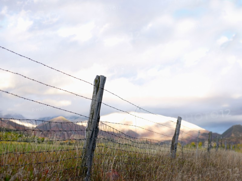 USA, Colorado, Mountain landscape with fence in foreground. Photo : John Kelly