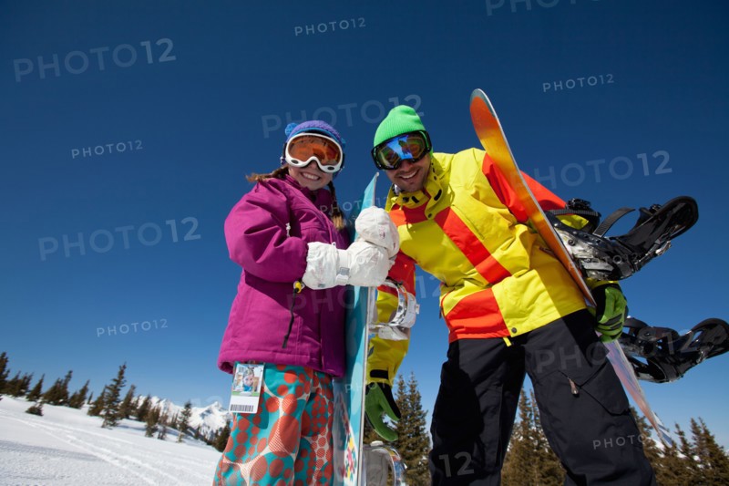 USA, Colorado, Telluride, Father and daughter (10-11) posing with snowboards in winter scenery. Photo : db2stock