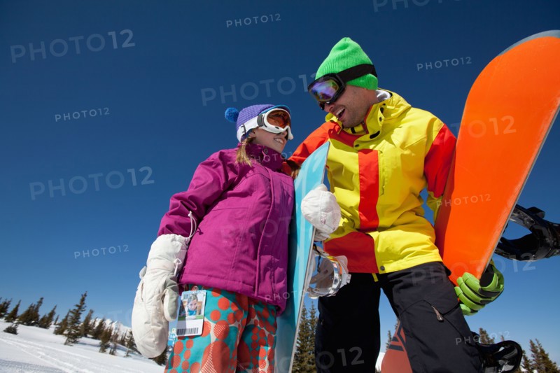 USA, Colorado, Telluride, Father and daughter (10-11) posing with snowboards in winter scenery. Photo : db2stock