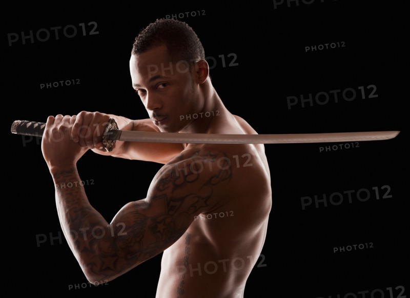 Studio shot of martial arts practitioner with Katana sword. Photo : Mike Kemp