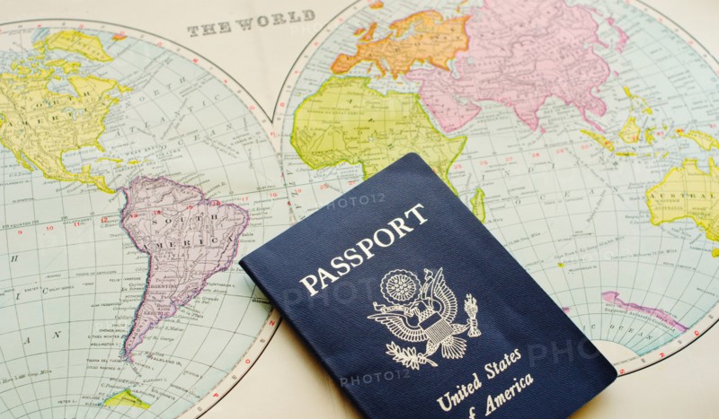Close-up of passport lying on map.