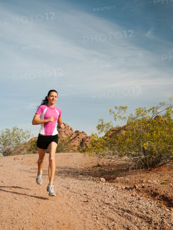 USA, Arizona, Phoenix, Young woman jogging on desert.